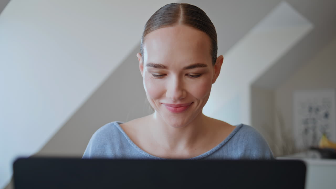 Dreamy manager taking break looking attic window at home with laptop closeup