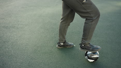 close-up leg view of an athlete trapping a soccer ball under his leg with precision and control during a practice session in a sports arena