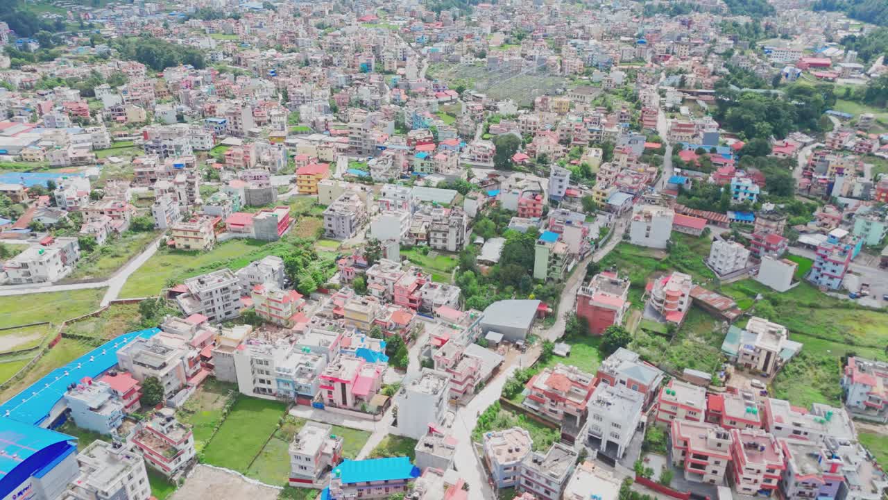 Aerial drone footage of Kathmandu Valley in Nepal, featuring sprawling cityscape, surrounding green hills, and the unique blend of urban and natural landscapes from above