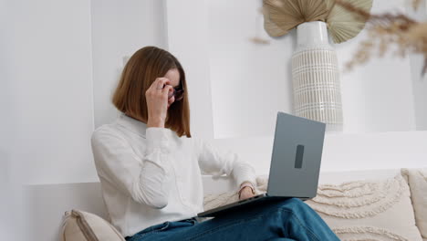 freelancing female employee working at her laptop. remote work at home far away from office.