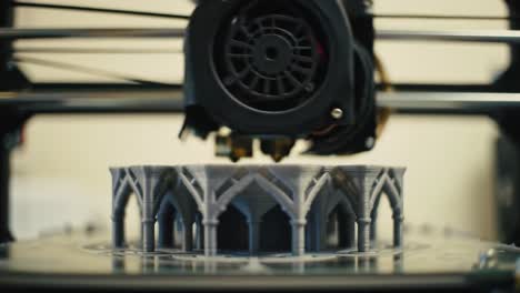 intricate 3d printing process captured: a close-up of a detailed architecture model being created layer by layer on a precision printer