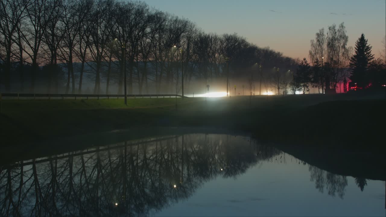 Car Traffic Light Reflections In The Water In The Evening. 4K Timelapse