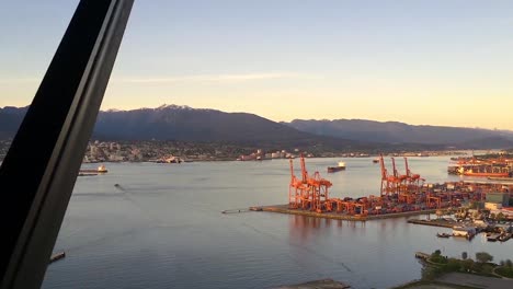 Top-of-Vancouver-aerial-panorama-of-city-life,-harbour-and-buildings-as-sun-sets