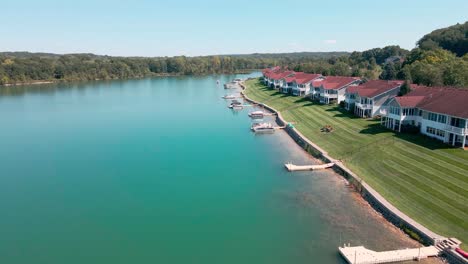 Dolly-motion-forward-over-lush-man-made-lake-near-condos