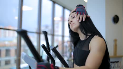 Woman with Telephone Training on Orbitrek in a Fitness Club Woman with Telephone Training on Orbitrek in a Fitness Club