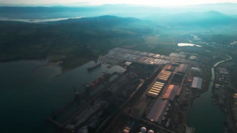 oil tanks, gas silos in harbor docks at sea koper city slovenia aerial, fossil fuel transportation over sea by oil tankers, green new deal transition to sustainability in trade, shipping containers