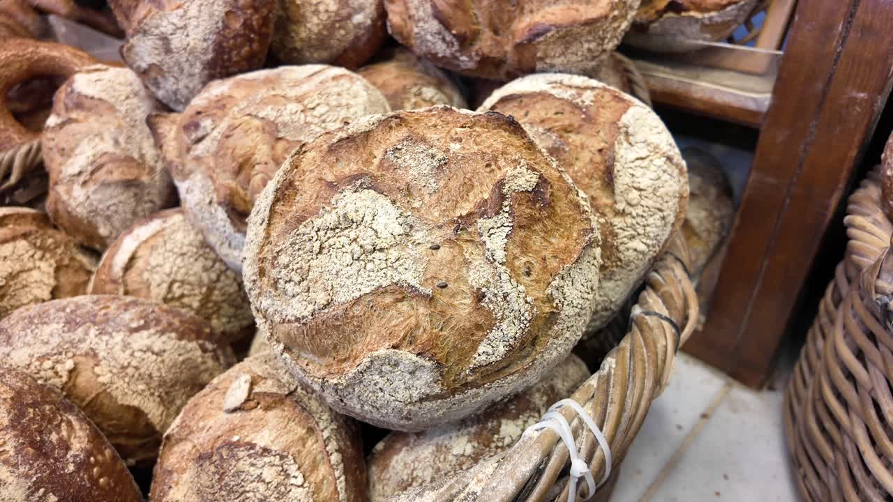 A variety of freshly baked sourdough bread loaves in a basket