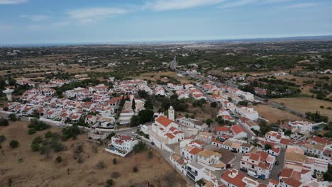 wide drone shot way over beautiful portugal algarve town of porches drone flying forward