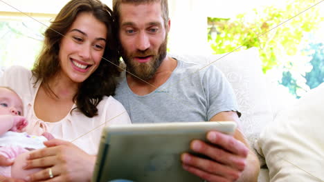 couple with children looking at tablet computer