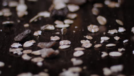 cereals falling on a dark wooden surface. low depth of field. high quality slowmotion 240fps.