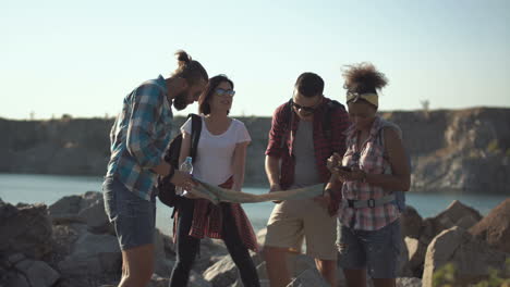 a group of friends hiking outdoors with a map