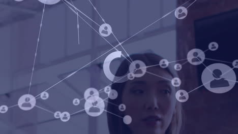 Animation of connections with digital icons over asian businesswoman in office