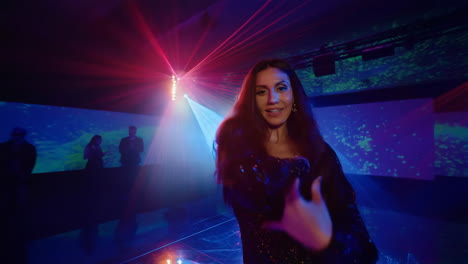 woman dancing energetically in a vibrant nightclub