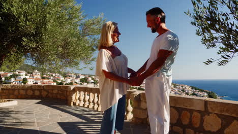 mature couple enjoying a romantic sea view from a mediterranean balcony