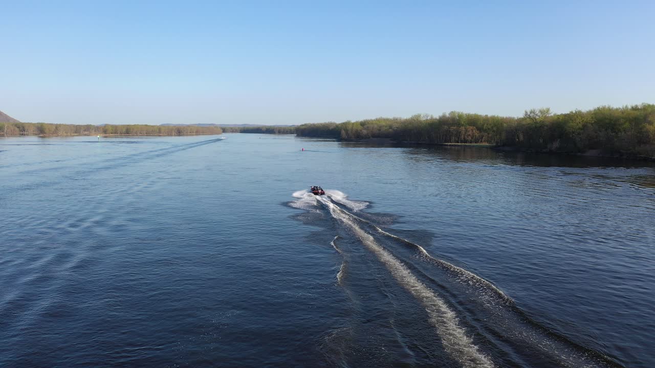 Aerial View of Boats Creating Wakes on a Wide River
