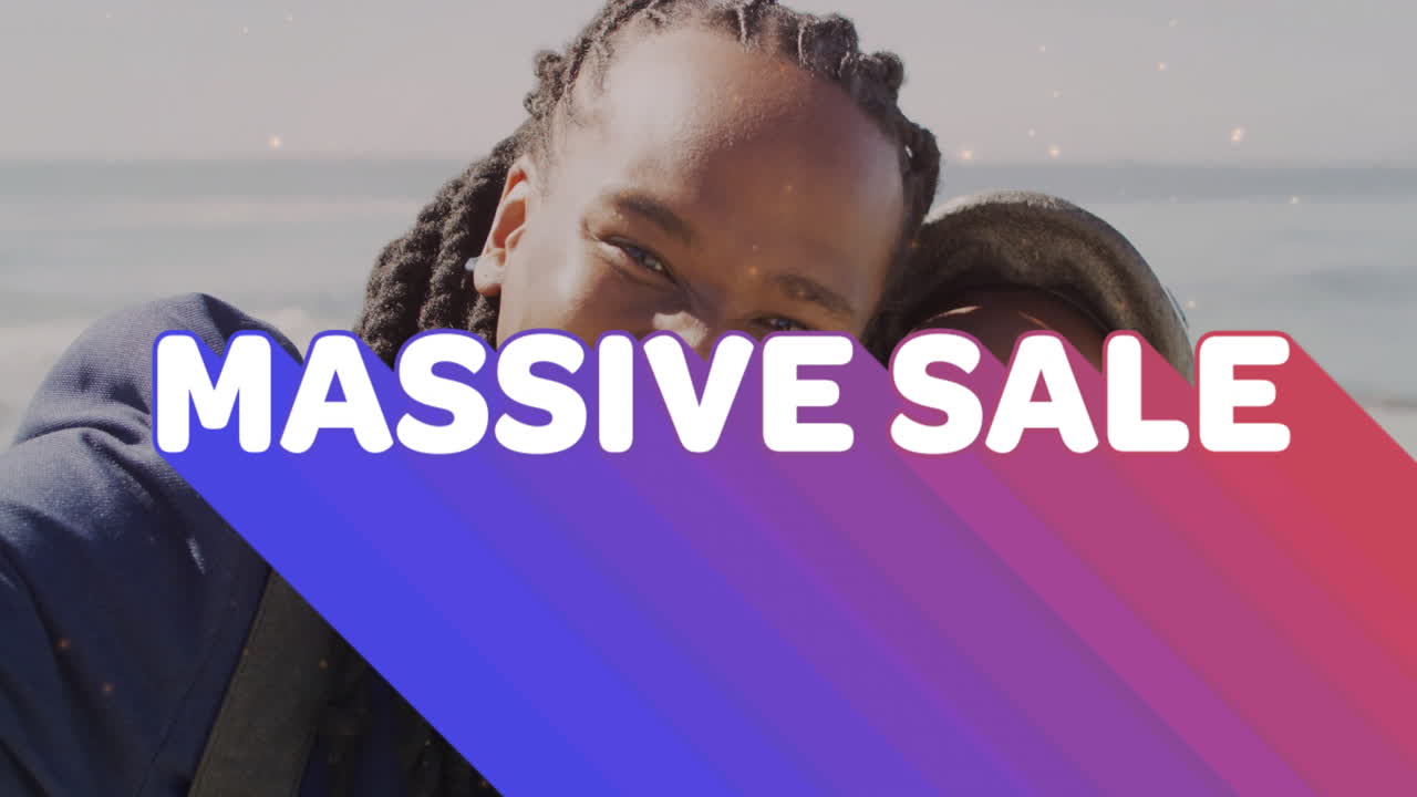 Massive sale text animation over smiling people at beach background
