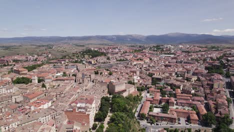 Tranquil-drone-view-across-medieval-city-center-to-mountains