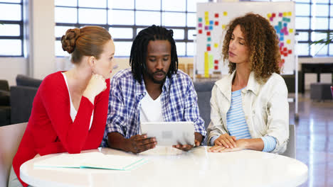 Colleagues-interacting-with-each-other-over-digital-tablet