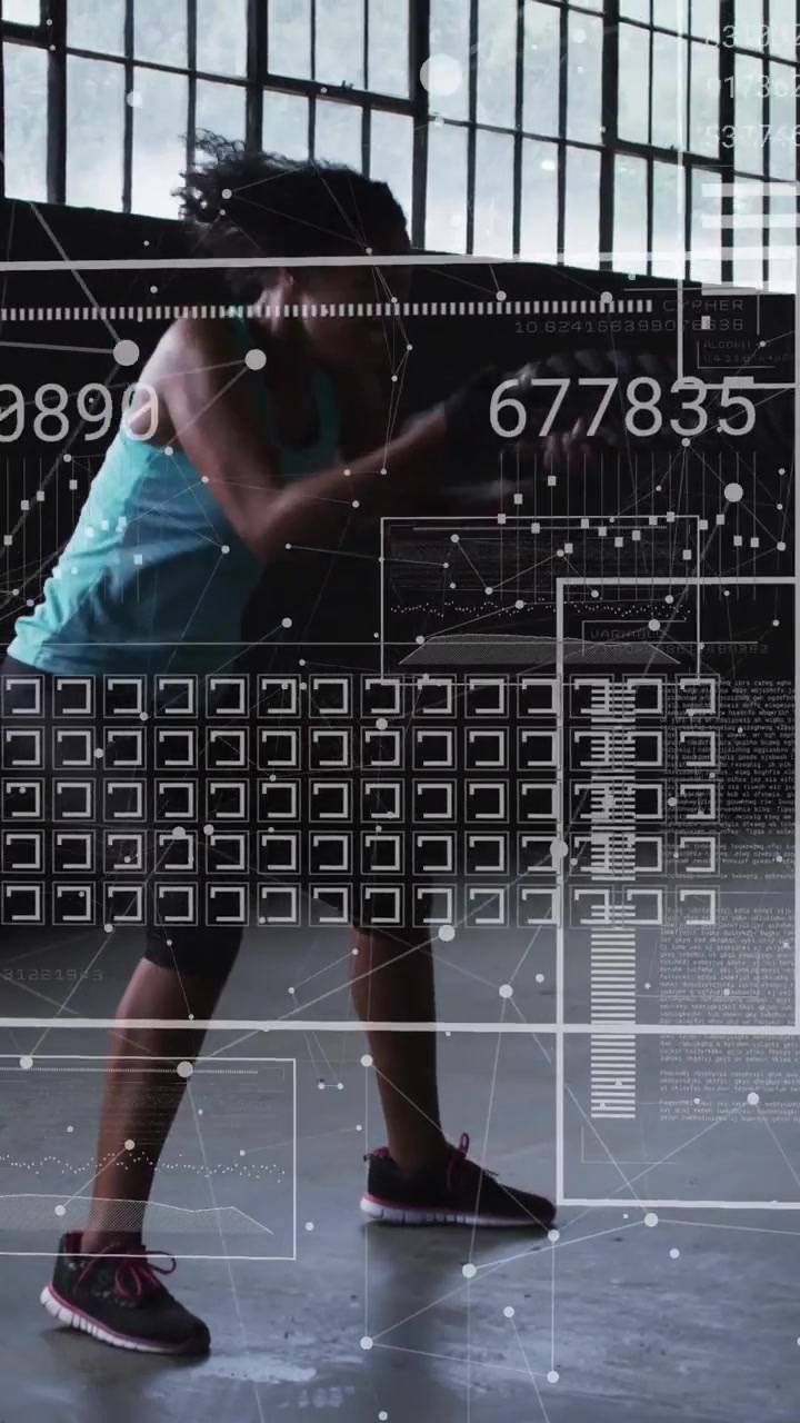 Woman performing battle-rope waves from low squat in warehouse gym, HUD tracking reps for fitness