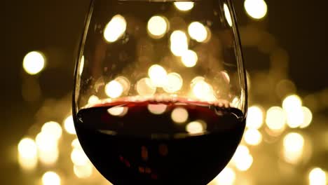 a captivating wine glass glimmering against a background of shimmering lights, pouring elegance and warmth into every sip perfect for intimate gatherings