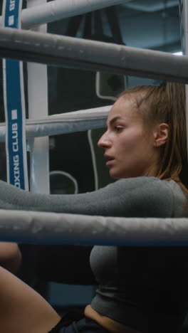 woman resting in boxing ring
