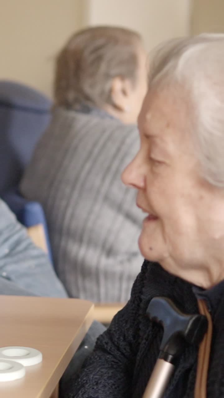Girl explaining rules of a game to a senior man