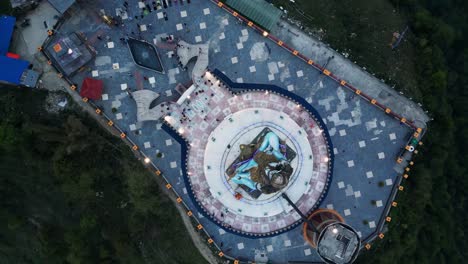 top down rotating drone view over lord shiva statue in pumdikot nepal