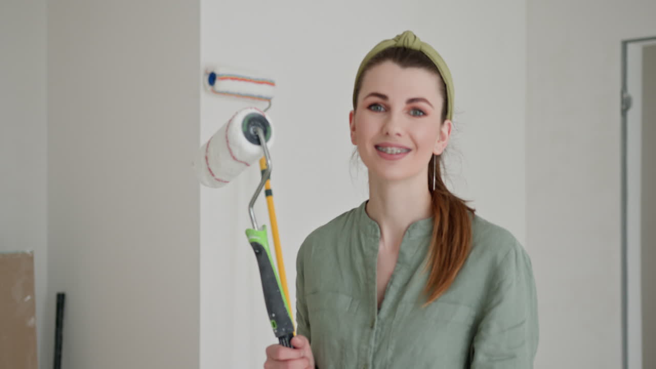 mujer con rodillo de pintura