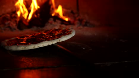 pizza baking in a wood-fired oven