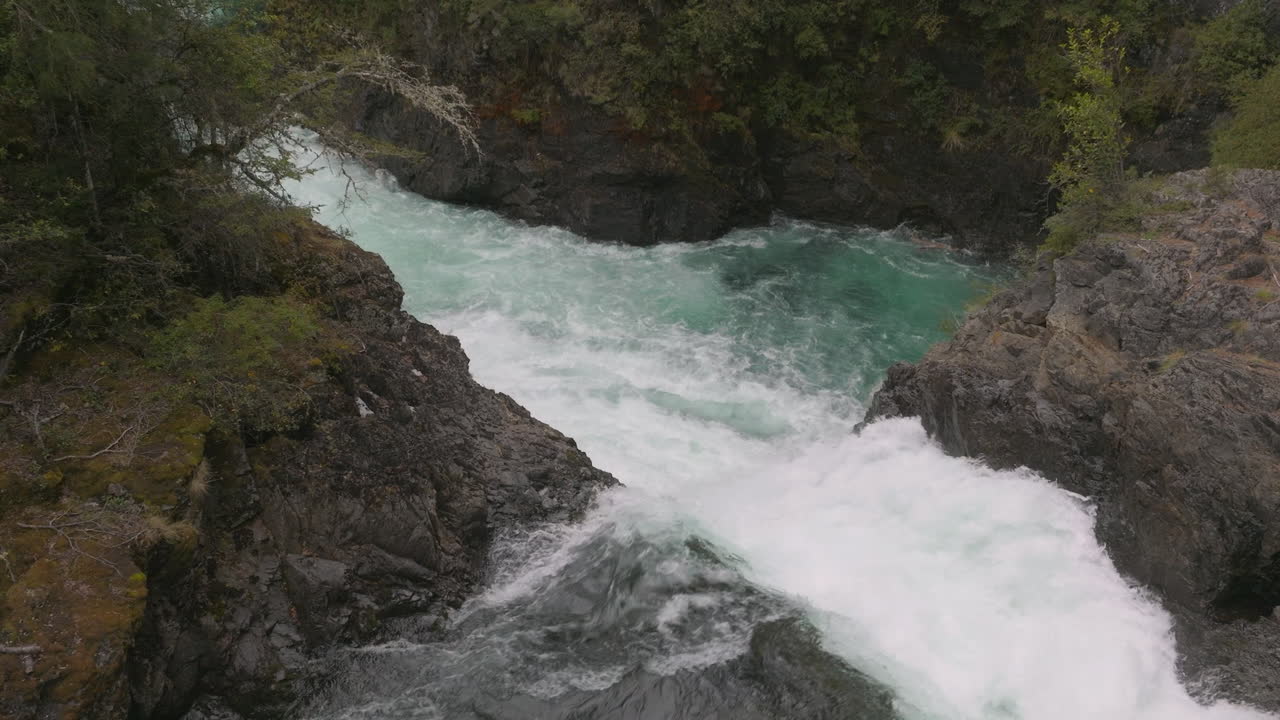 Breathtaking drone shot flying slowly over a powerful waterfall in Argentina