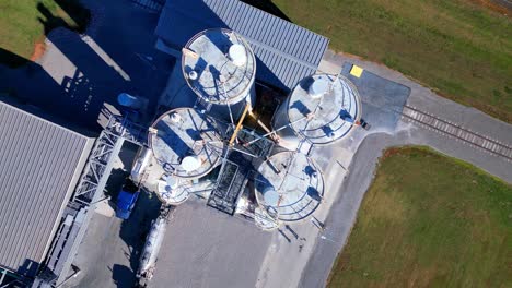 aerial top down of material containment cylinder tanks at an industrial factory