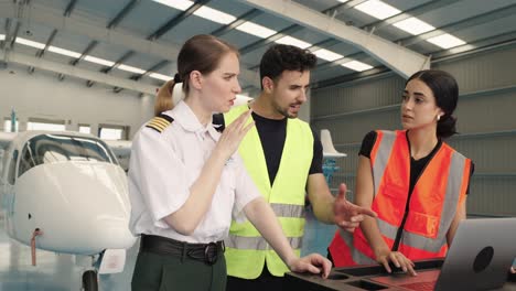 aviation professionals collaborating in airplane hangar