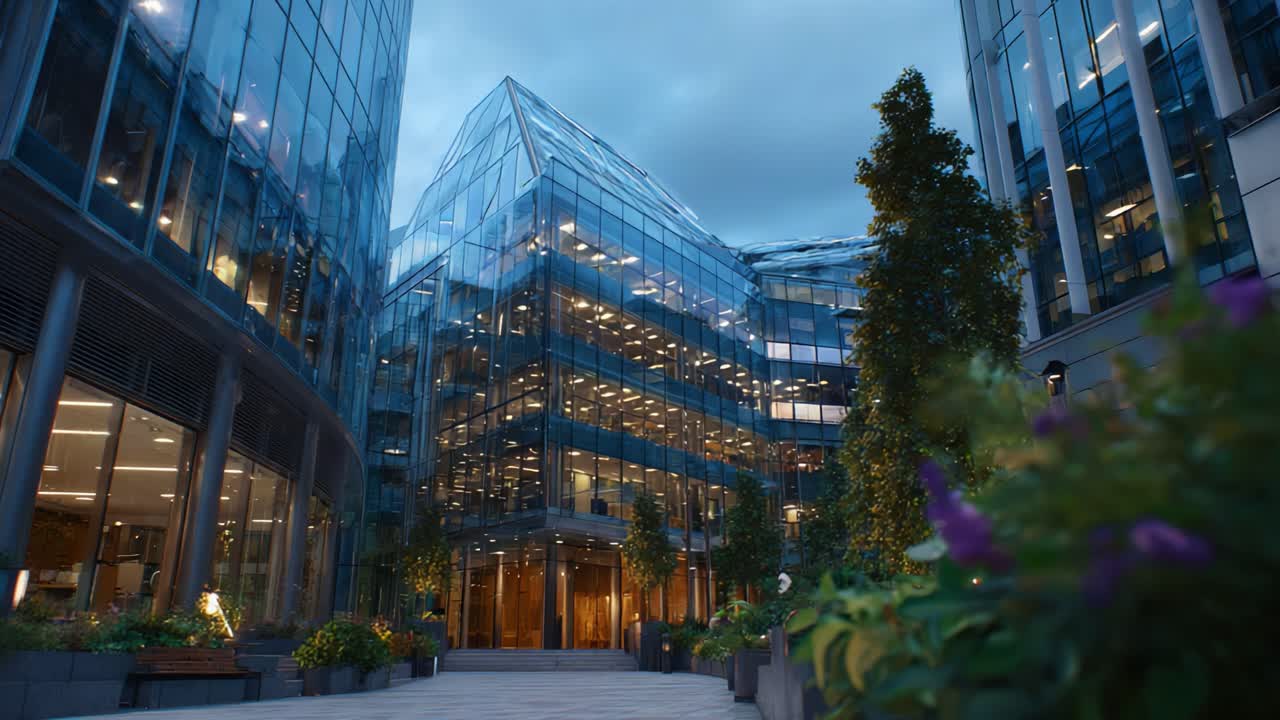 Modern glass architecture featuring a beautifully designed commercial building surrounded by greenery, showcasing a blend of nature and contemporary design aesthetics