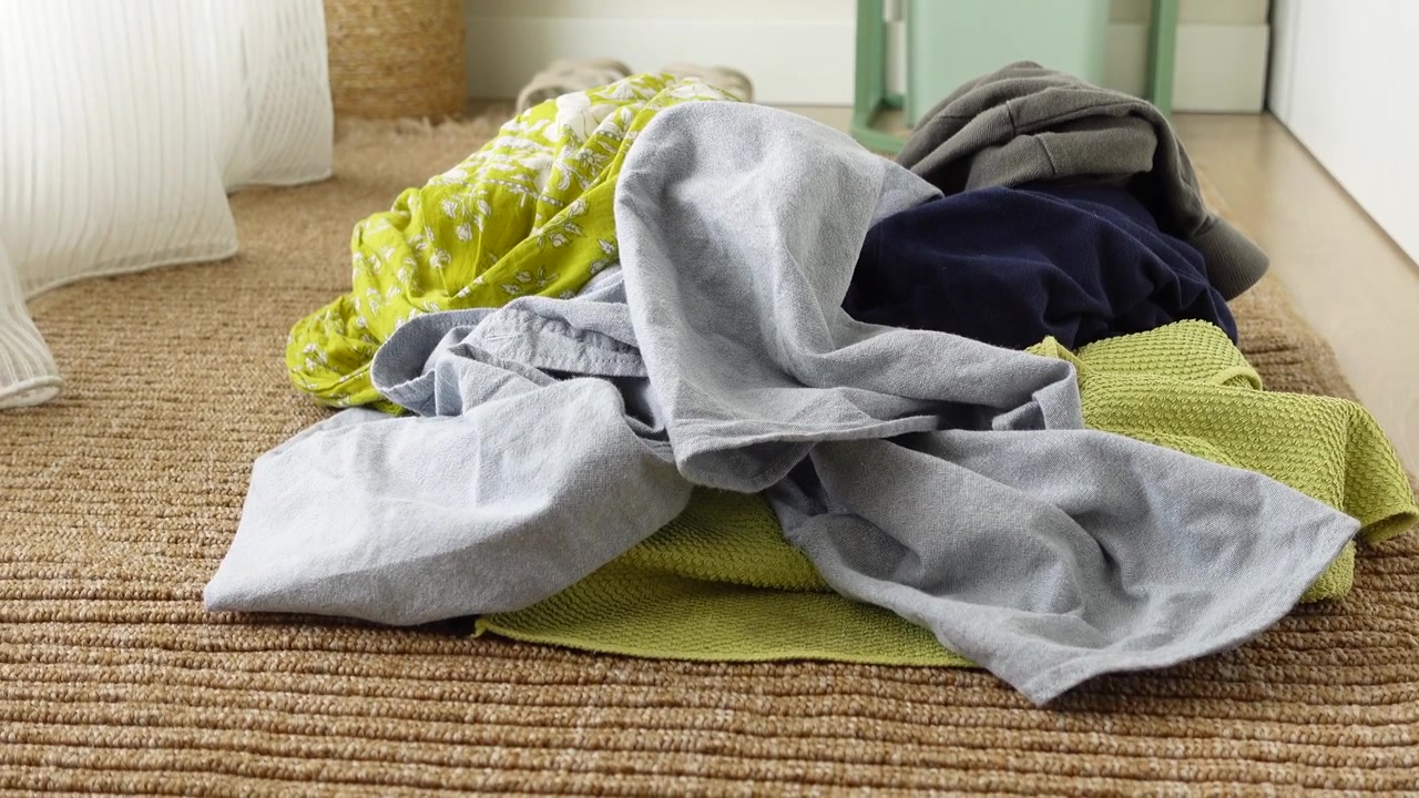 Pile of Unsorted Laundry on a Woven Rug