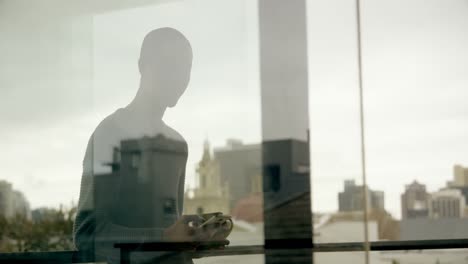 Man-standing-in-balcony-at-home-4k