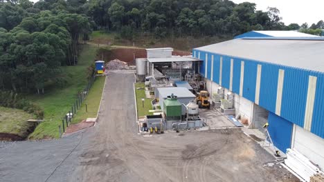 get closer to the action: drone shot captures the approach towards the factory warehouse machines, revealing the industrial process