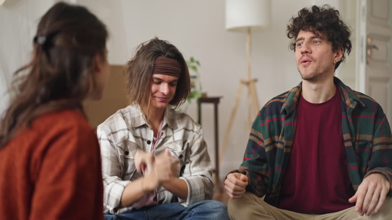 Group of friends having a conversation in a living room.