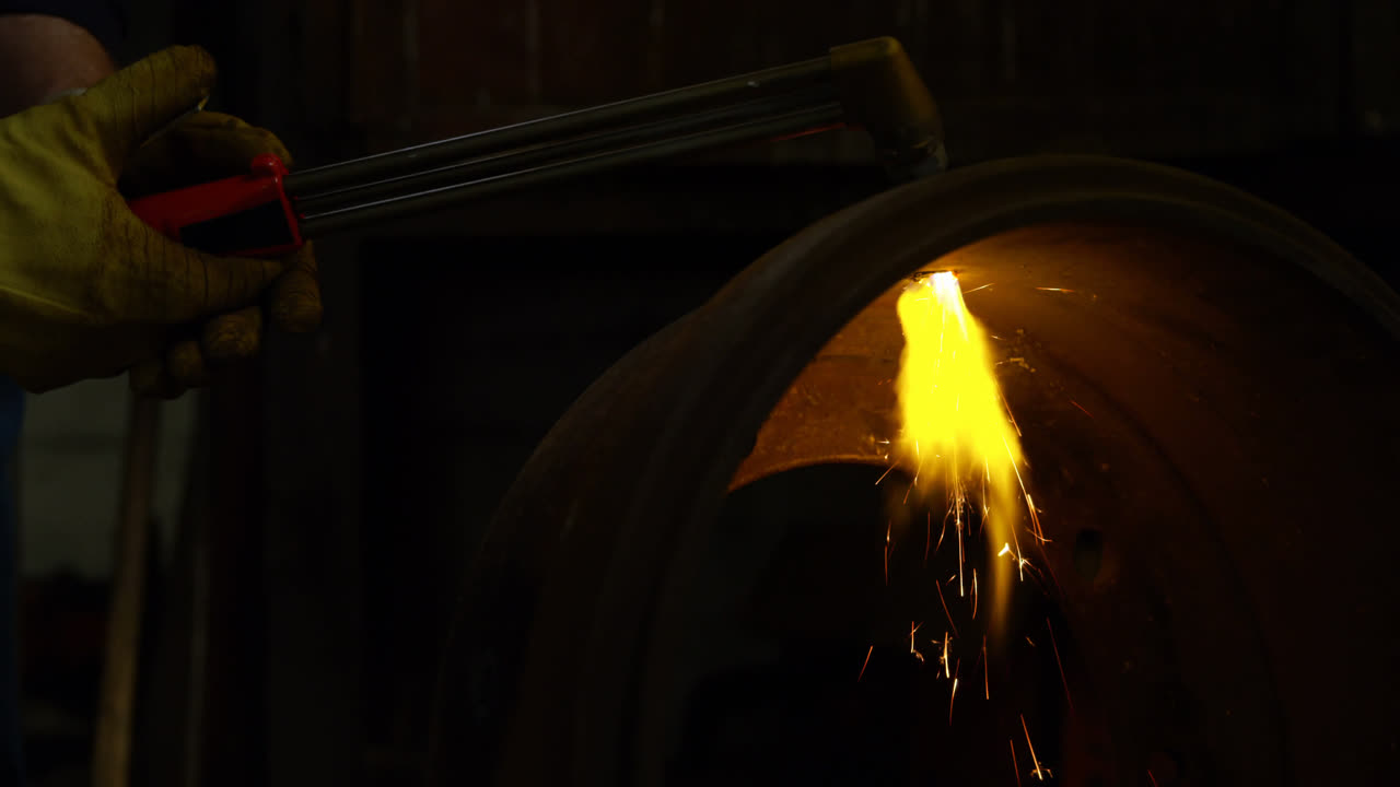 Metalsmith using welding torch in workshop 4k