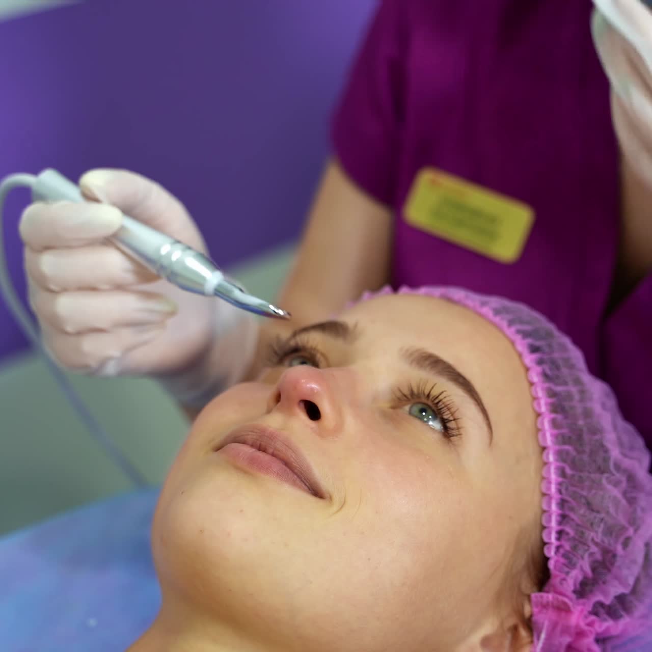 Beautician provides beauty manipulations with client`s face. Anti aging procedures. Beauty clinic