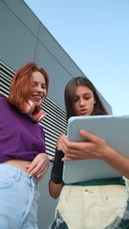 teenage girls looking at a tablet