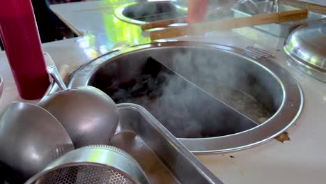 street food stall with boiling soup