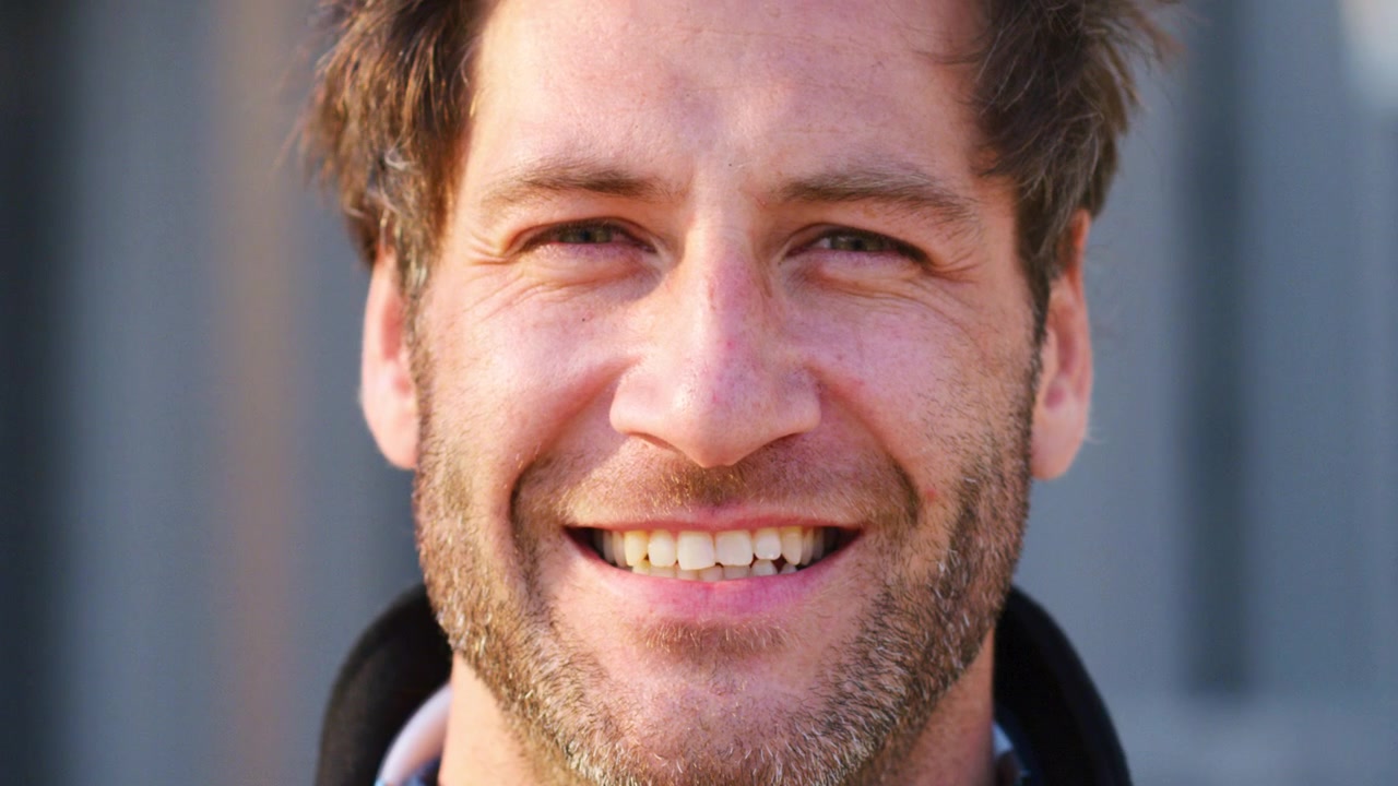 Close-up Portrait of a Smiling Man Looking at Camera