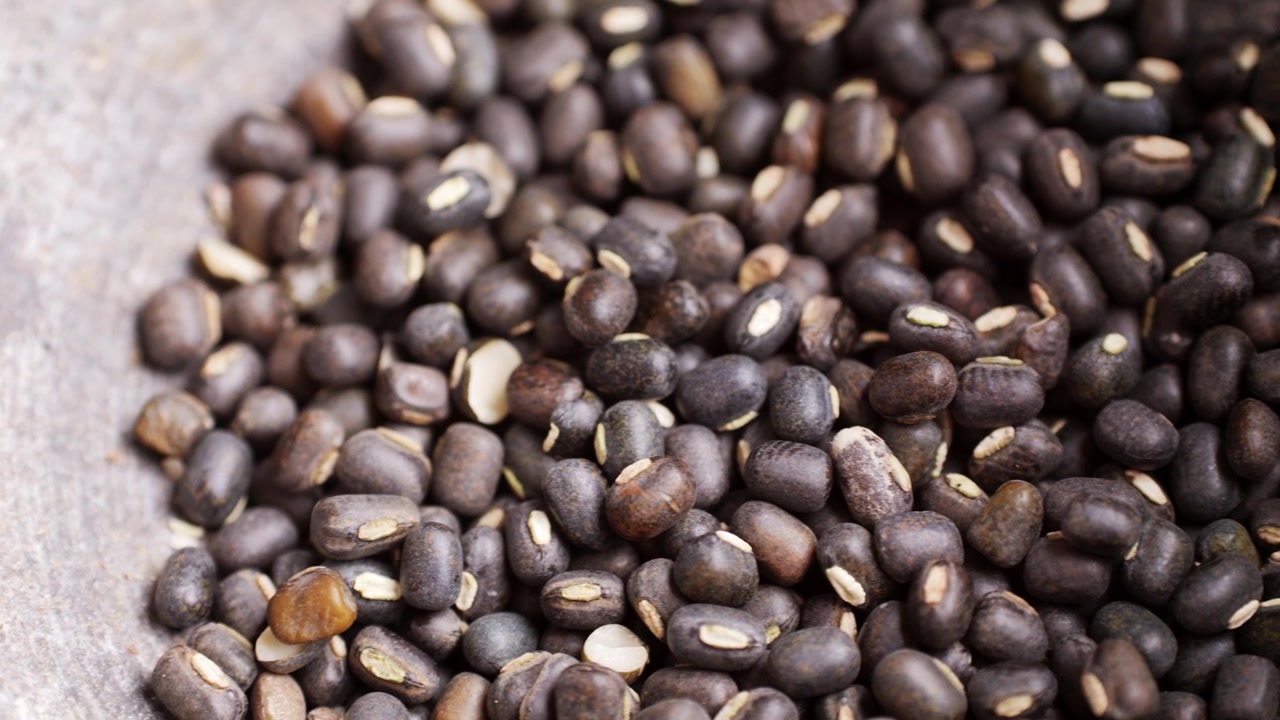 Close-up of Raw Black Gram Beans in a Rustic Bowl