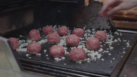 Beef-meatballs-fried-on-stone-grill-together-with-diced-onion