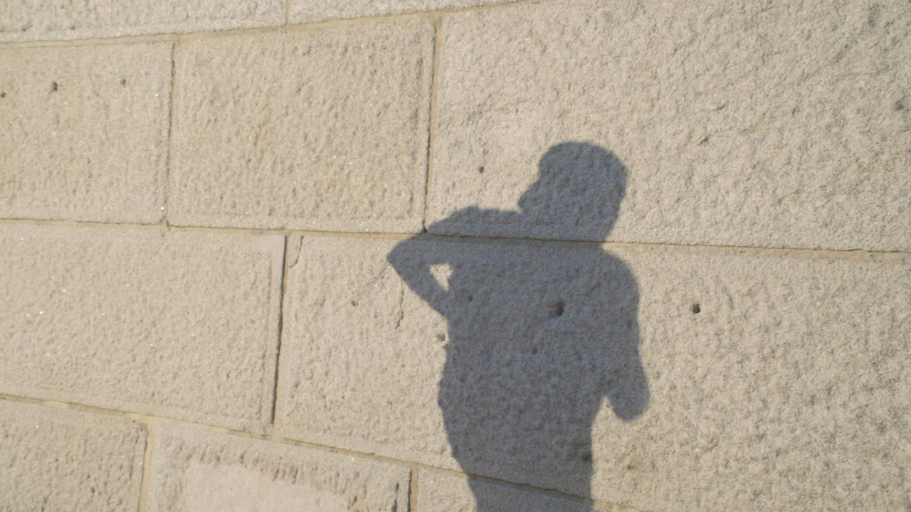 Shadow of a man running at sunset. Shot in slow motion