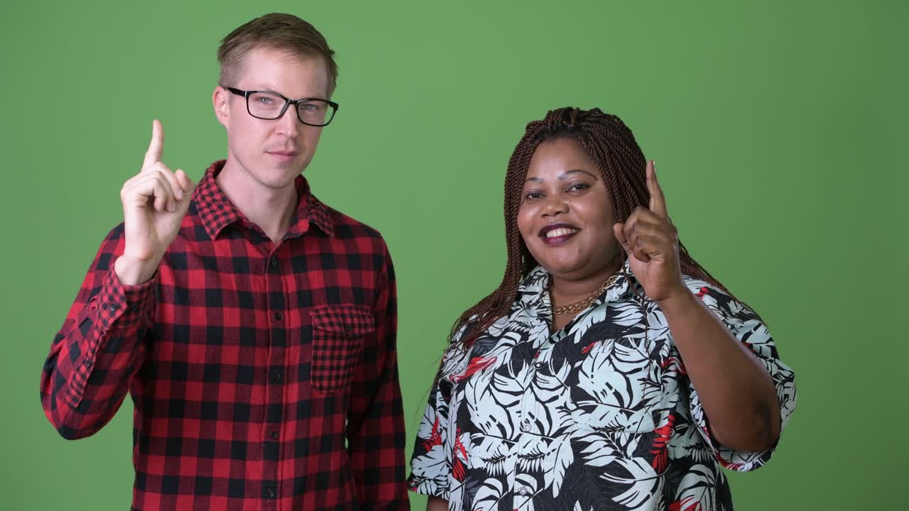 Overweight African woman and young Scandinavian man together against green background