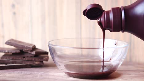 pouring chocolate syrup into a bowl