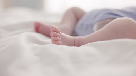 sleeping, dreaming and feet of baby on bed