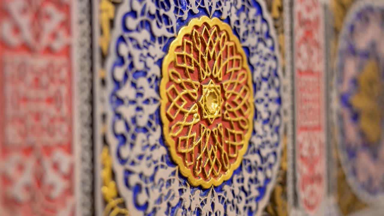 Spain's Aranjuez Royal Palace: Museum exhibition detail revealing intricate, historic Islamic or Mudéjar patterns; a close-up of exquisite decorative art craftsmanship.