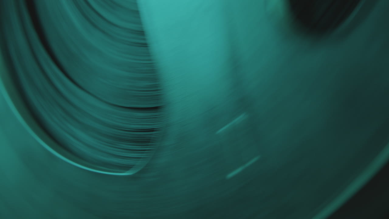 Macro Shot of Reel-to-Reel Tape Recorder in Blue Neon Light